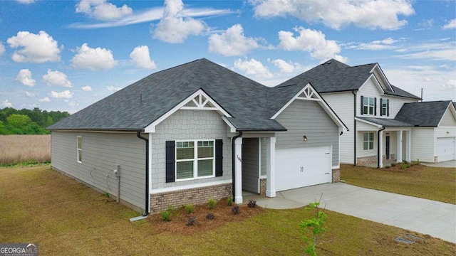 view of front of property with a front yard and a garage