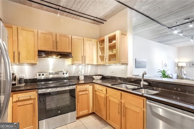 kitchen featuring stainless steel appliances, light brown cabinetry, sink, and light tile patterned floors