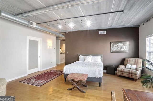 bedroom with wood-type flooring