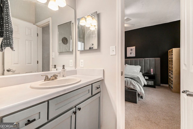 bedroom with ceiling fan, light colored carpet, and a textured ceiling