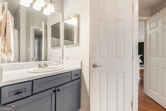 bathroom featuring ceiling fan and vanity