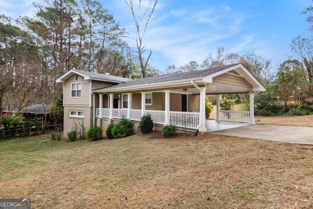 view of front of property with covered porch, a front yard, and a carport