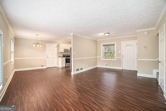 unfurnished living room with a chandelier, dark hardwood / wood-style floors, and ornamental molding