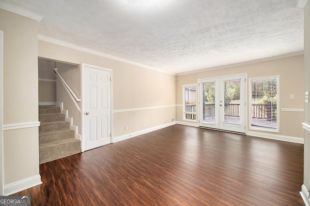 interior space with a textured ceiling, crown molding, dark wood-type flooring, and french doors