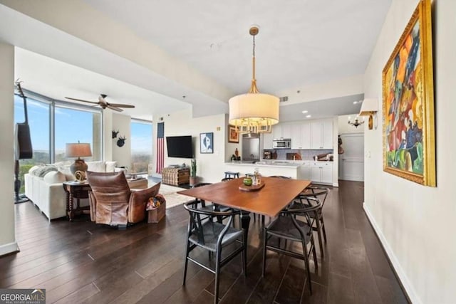 dining area with ceiling fan and dark hardwood / wood-style flooring