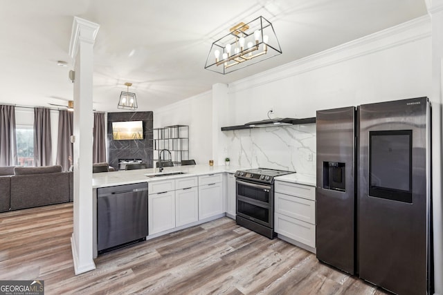 kitchen featuring sink, tasteful backsplash, light hardwood / wood-style floors, white cabinets, and appliances with stainless steel finishes