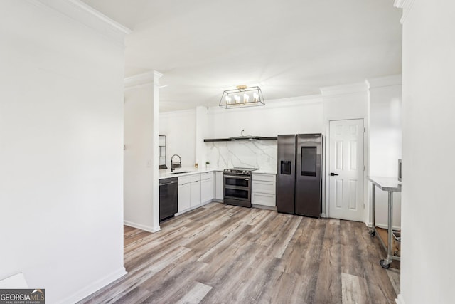 kitchen featuring tasteful backsplash, sink, white cabinets, and stainless steel appliances