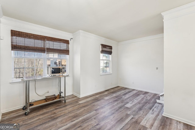 empty room featuring hardwood / wood-style flooring and crown molding