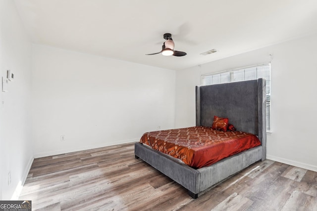 bedroom featuring hardwood / wood-style flooring and ceiling fan