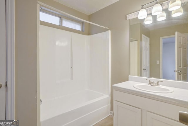 bathroom featuring tile patterned flooring, vanity, and shower / washtub combination