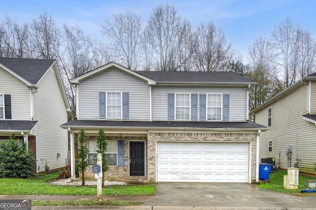 view of front property with a garage and central AC unit