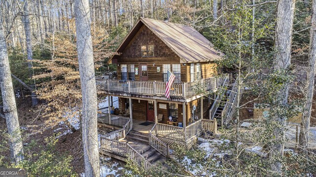 view of front of property with a deck with water view