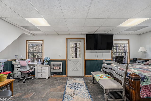 interior space featuring a drop ceiling and heating unit