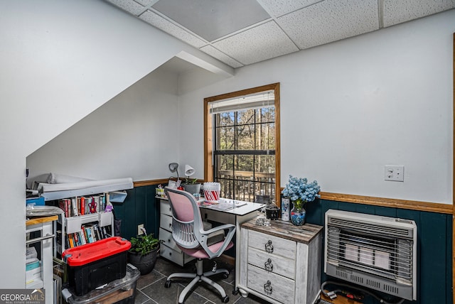 office area featuring heating unit, a paneled ceiling, and dark tile patterned flooring