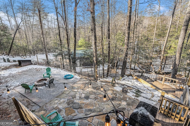 snow covered patio with a fire pit