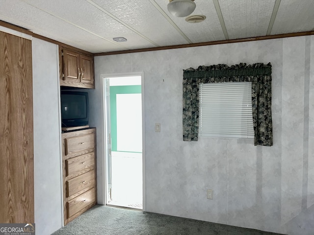 kitchen featuring crown molding and light colored carpet