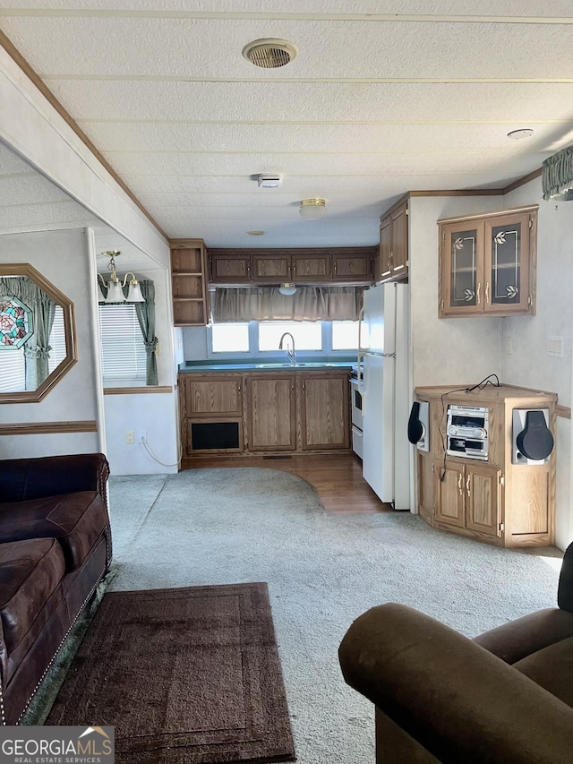 living room with light carpet, sink, and a textured ceiling