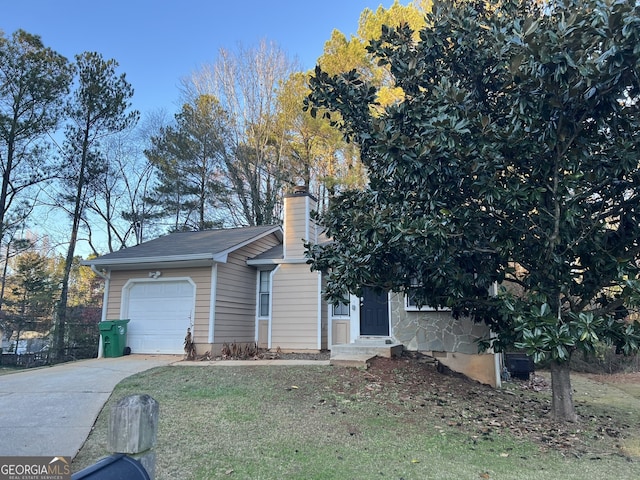 view of front of property with a garage and a front lawn