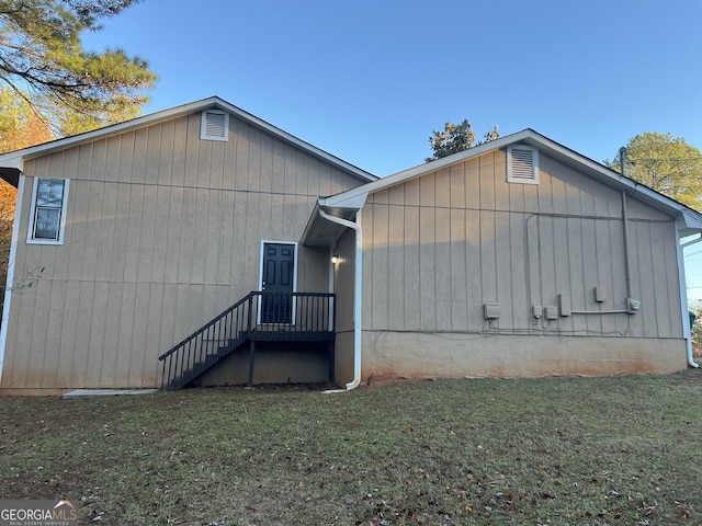 view of side of home with a yard