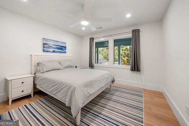 bedroom with ceiling fan and light hardwood / wood-style flooring