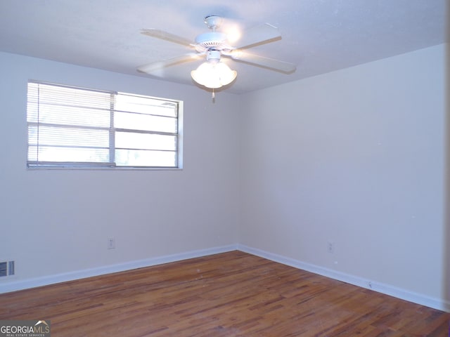 unfurnished room with hardwood / wood-style flooring and ceiling fan