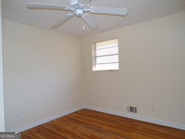 empty room featuring hardwood / wood-style flooring and ceiling fan