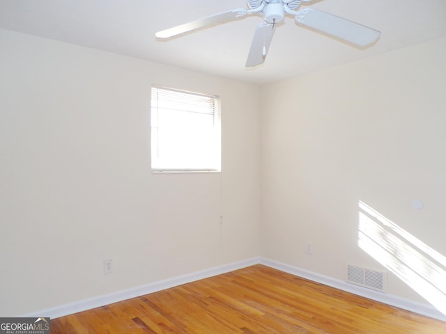 spare room with hardwood / wood-style floors and ceiling fan