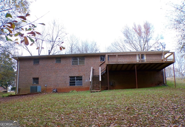 rear view of property featuring a wooden deck, a yard, and central AC unit