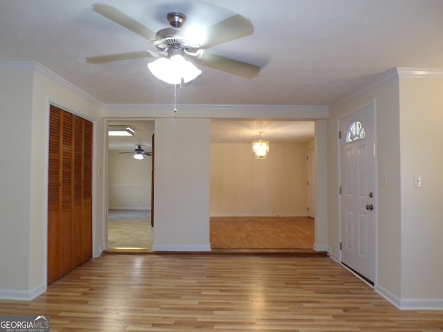 unfurnished room featuring ornamental molding, light hardwood / wood-style floors, and ceiling fan