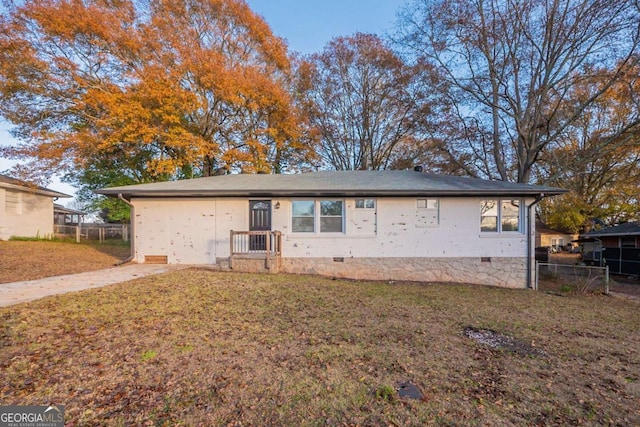 rear view of property featuring a yard