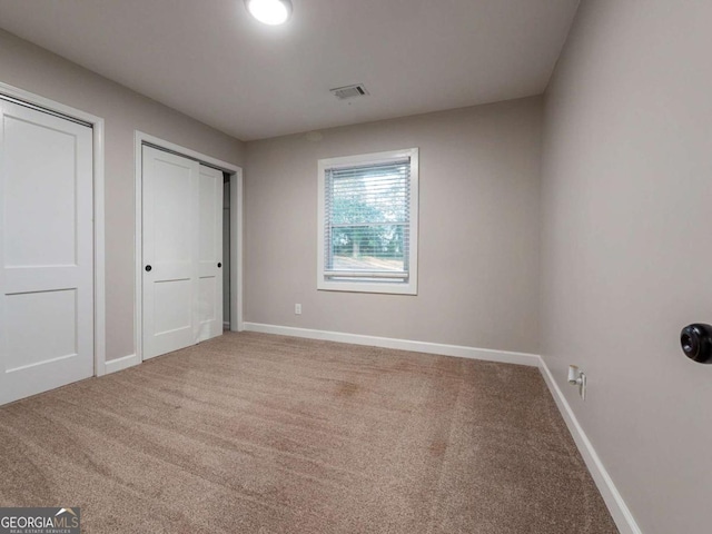 unfurnished bedroom with carpet floors