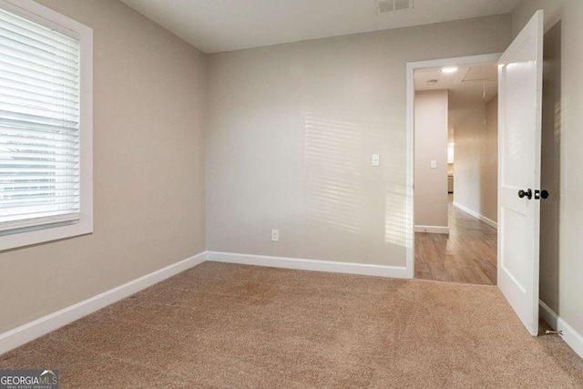 empty room featuring light carpet