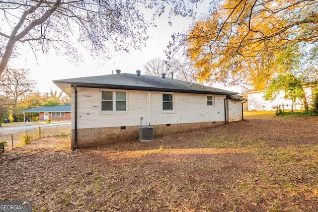 back of house with central AC unit