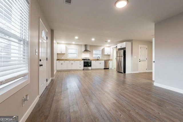 unfurnished living room with hardwood / wood-style floors and sink