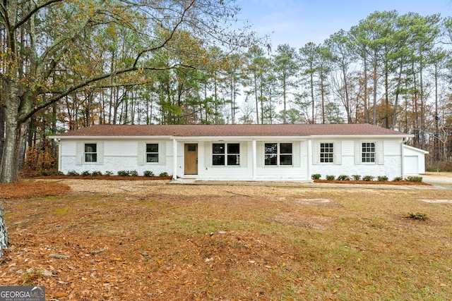 single story home with a garage and an outdoor structure