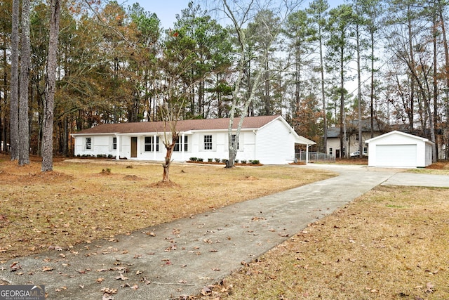 view of front of property featuring a garage, an outdoor structure, and a front lawn