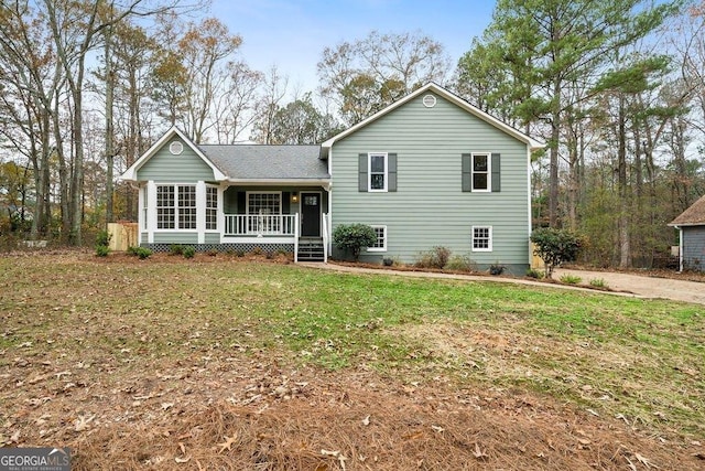 split level home with a front lawn and a porch