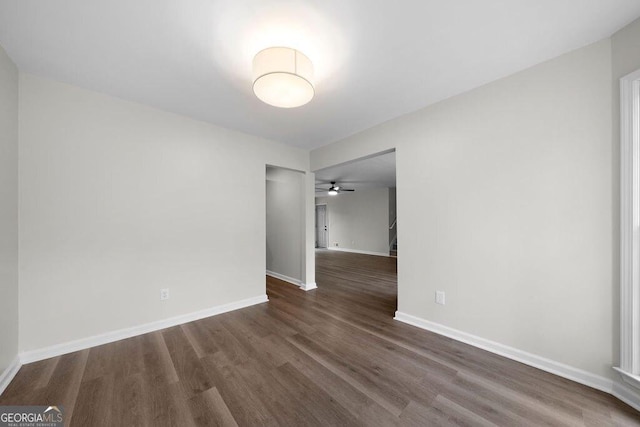 unfurnished room with dark hardwood / wood-style flooring