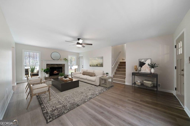 living room featuring a fireplace, ceiling fan, and hardwood / wood-style floors