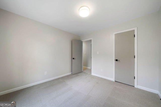 unfurnished bedroom featuring light colored carpet