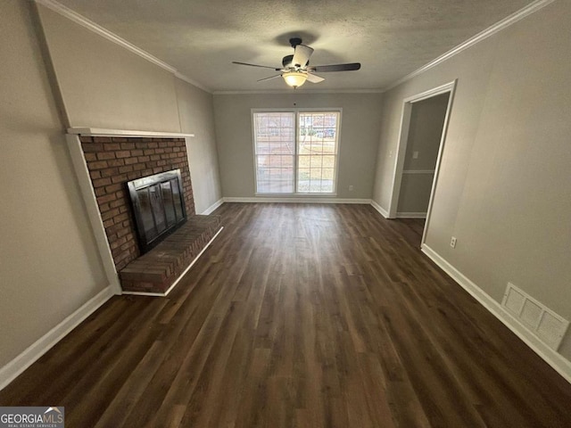 unfurnished living room featuring ceiling fan, dark hardwood / wood-style flooring, ornamental molding, and a brick fireplace