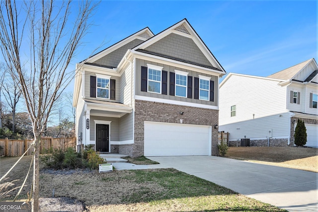 view of front of property featuring a garage and central AC unit