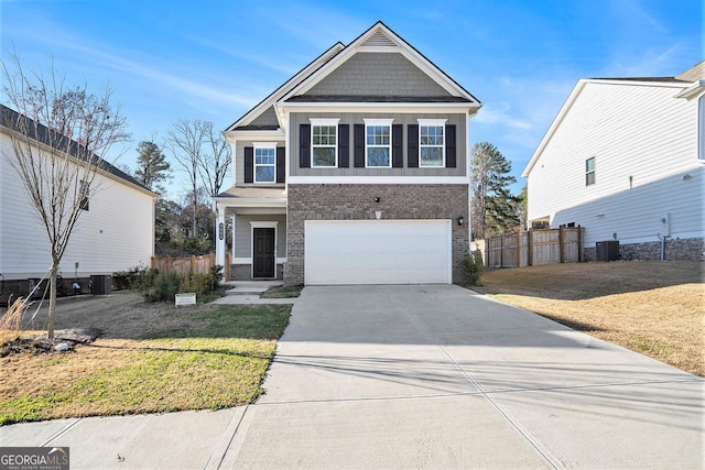 view of front of house featuring central air condition unit, a front lawn, and a garage