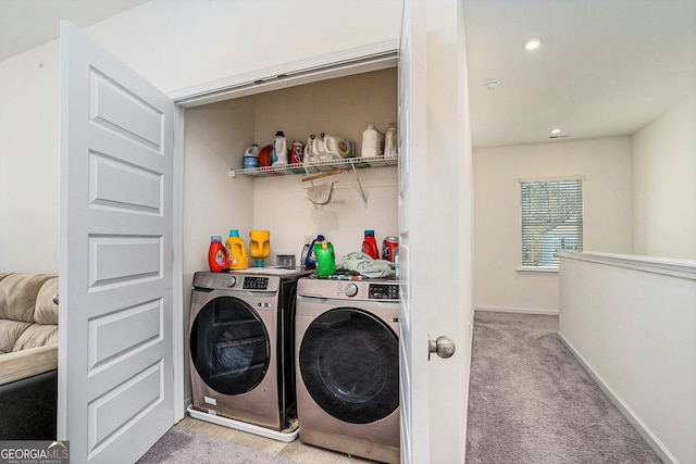 laundry room with washing machine and dryer and light carpet