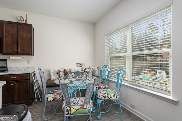 dining area featuring dark wood-type flooring