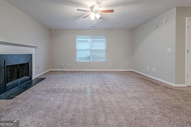 unfurnished living room with ceiling fan, carpet floors, and a textured ceiling