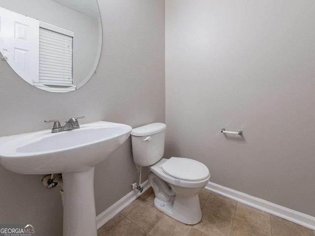 bathroom with tile patterned floors and toilet