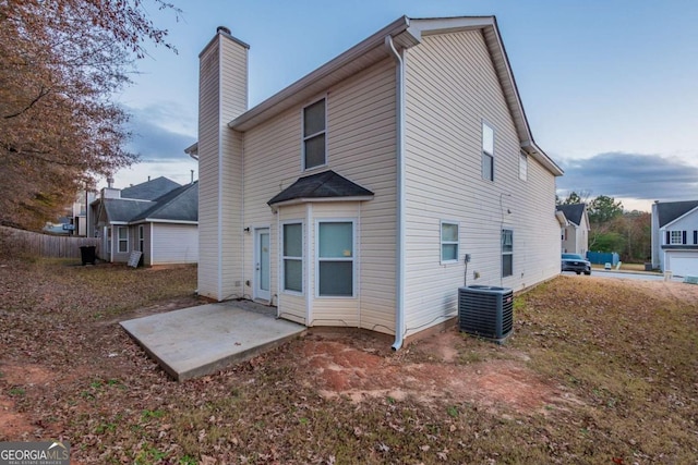 rear view of house with a patio and central air condition unit