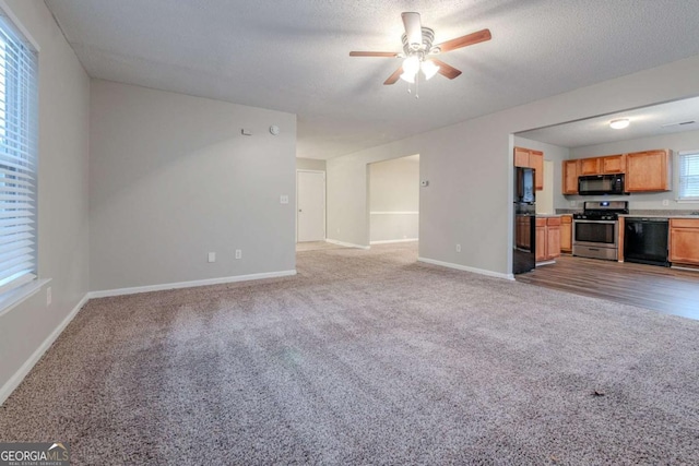 unfurnished living room featuring a textured ceiling, light colored carpet, and ceiling fan