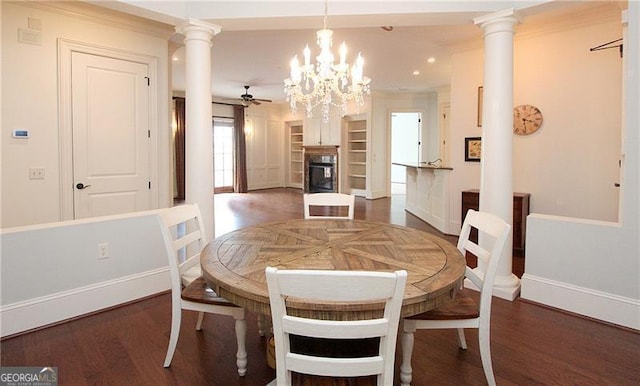 dining area featuring baseboards, wood finished floors, a glass covered fireplace, ornate columns, and recessed lighting